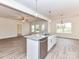 Modern kitchen features a granite island, stainless appliances, view to living area, and light floors at 5609 Morgan Mill Rd, Monroe, NC 28110