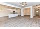 Open-concept kitchen with white cabinets, granite countertops, stainless steel appliances, and pendant lighting at 5609 Morgan Mill Rd, Monroe, NC 28110