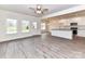 Open living space with stainless appliances, light floors, kitchen island, and view to backyard at 5609 Morgan Mill Rd, Monroe, NC 28110