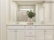 Bathroom featuring double vanity, quartz countertop, white cabinets, and tiled shower with glass door at 5710 Olive Beach Rd, Kannapolis, NC 28081