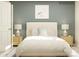 Serene bedroom with a plush bed, stylish lamps, and neutral tones at 5710 Olive Beach Rd, Kannapolis, NC 28081