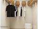 Organized closet with clothing hung neatly and woven baskets on shelves for storage at 5710 Olive Beach Rd, Kannapolis, NC 28081