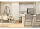 Bright kitchen with white cabinets, stainless steel appliances, and a casual dining area at 5710 Olive Beach Rd, Kannapolis, NC 28081