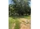 Backyard with mature trees and some outbuildings at 5949 Flat Creek Rd, Kershaw, SC 29067