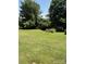Expansive backyard with mature trees and a well-maintained lawn at 5949 Flat Creek Rd, Kershaw, SC 29067