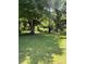 Spacious backyard with lush greenery and mature trees offering shade at 5949 Flat Creek Rd, Kershaw, SC 29067