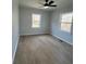 This bedroom features wood-look flooring, a ceiling fan, and two windows at 5949 Flat Creek Rd, Kershaw, SC 29067