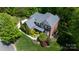 Spacious home with lush landscaping, mature trees, and a well-maintained yard at 653 Buckleigh Nw Ct, Concord, NC 28027