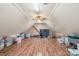Finished attic space with hardwood floors, a ceiling fan, and ample storage options at 653 Buckleigh Nw Ct, Concord, NC 28027