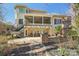 Backyard with a covered patio and stone fireplace ideal for outdoor living at 653 Buckleigh Nw Ct, Concord, NC 28027