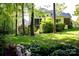 Lush green backyard with mature trees and landscaping offering privacy and a serene setting at 653 Buckleigh Nw Ct, Concord, NC 28027
