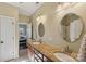 Bathroom with double sinks, granite countertops, wooden cabinets, and large mirrors at 653 Buckleigh Nw Ct, Concord, NC 28027