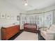 Bright Bedroom featuring a crib, changing table, white rug, and windows with light-filtering curtains at 653 Buckleigh Nw Ct, Concord, NC 28027