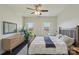Well-lit bedroom features hardwood floors, large windows with shutters, a ceiling fan, and neutral colors at 653 Buckleigh Nw Ct, Concord, NC 28027