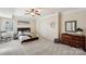 Comfortable bedroom featuring neutral walls, carpet flooring, a ceiling fan, and a queen bed at 653 Buckleigh Nw Ct, Concord, NC 28027