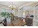 Elegant dining room with dark hardwood floors, a chandelier, and bright natural light at 653 Buckleigh Nw Ct, Concord, NC 28027