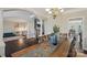Elegant dining room with dark hardwood floors, a chandelier, and views into other living spaces at 653 Buckleigh Nw Ct, Concord, NC 28027
