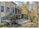 Exterior view of a home with a covered deck, stone patio, and beautiful landscaping at 653 Buckleigh Nw Ct, Concord, NC 28027