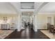 Open concept foyer with dark hardwood floors, an elegant staircase, and neutral walls at 653 Buckleigh Nw Ct, Concord, NC 28027