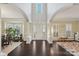 Grand foyer with soaring ceilings, arched entryways, and dark hardwood floors at 653 Buckleigh Nw Ct, Concord, NC 28027