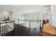 Bright, open hallway featuring dark hardwood floors, white railings, and arched windows at 653 Buckleigh Nw Ct, Concord, NC 28027