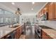 Bright kitchen boasting stainless steel appliances, granite countertops, and an adjacent dining area at 653 Buckleigh Nw Ct, Concord, NC 28027