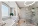 Stylish main bathroom with a soaking tub, walk-in shower, and elegant fixtures for a spa-like experience at 653 Buckleigh Nw Ct, Concord, NC 28027
