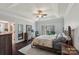 Comfortable main bedroom featuring a large window, elegant furnishings, and an ensuite bathroom at 653 Buckleigh Nw Ct, Concord, NC 28027