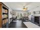 Bright home office features hardwood floors, a ceiling fan, two desks, and ample natural light at 653 Buckleigh Nw Ct, Concord, NC 28027