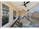 Covered outdoor patio with comfortable seating and a ceiling fan perfect for entertaining guests at 653 Buckleigh Nw Ct, Concord, NC 28027