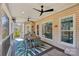 Covered outdoor patio with dining table, ceiling fans, and wooded views for relaxing and entertaining at 653 Buckleigh Nw Ct, Concord, NC 28027