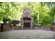 Outdoor stone fireplace and patio create the perfect place to relax at 653 Buckleigh Nw Ct, Concord, NC 28027