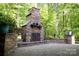 Stunning outdoor stone fireplace and stone patio create a relaxing and inviting space at 653 Buckleigh Nw Ct, Concord, NC 28027