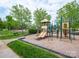 Community playground with slides and climbing structures surrounded by green space and mature trees at 653 Buckleigh Nw Ct, Concord, NC 28027