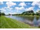 Picturesque pond view with a fountain, lush green shoreline, and stately homes in the background at 653 Buckleigh Nw Ct, Concord, NC 28027