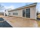 Exterior backyard view featuring a patio, sliding glass doors to the home, and a tidy lawn at 7047 Whittingham Dr, Indian Land, SC 29707