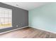 Comfortable bedroom featuring two-toned walls, a bright window and vinyl floors at 7047 Whittingham Dr, Indian Land, SC 29707