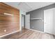 Stylish bedroom with wood accent wall, light blue and gray paint scheme and wood floors at 7047 Whittingham Dr, Indian Land, SC 29707