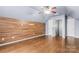 Bedroom featuring wood floors, accent wall and a ceiling fan, and neutral color palette at 7047 Whittingham Dr, Indian Land, SC 29707