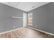 Gray bedroom featuring a large window, neutral walls, modern lighting, and vinyl floors at 7047 Whittingham Dr, Indian Land, SC 29707