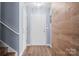 Welcoming entryway with neutral walls, wood floors, decorative wall panels, and a classic white front door at 7047 Whittingham Dr, Indian Land, SC 29707