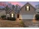 Charming single-Gathering home with attached garage, well-maintained lawn, and inviting front entrance at 7047 Whittingham Dr, Indian Land, SC 29707