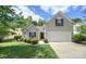 Charming two-story home featuring a well-manicured lawn, complemented by lush landscaping, and a two car garage at 7047 Whittingham Dr, Indian Land, SC 29707