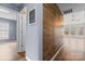 Hallway featuring stylish wood accent wall, light blue painted walls, and inviting views of adjacent rooms at 7047 Whittingham Dr, Indian Land, SC 29707