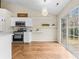 Charming kitchen with modern appliances, white cabinets, and an adjacent dining nook with sliding glass door at 7047 Whittingham Dr, Indian Land, SC 29707