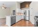 Bright kitchen featuring stainless steel appliances, white cabinets, light backsplash, and beautiful wood flooring at 7047 Whittingham Dr, Indian Land, SC 29707