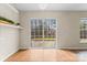 Bright living room featuring a glass sliding door, herringbone wood floors, and simple floating shelves at 7047 Whittingham Dr, Indian Land, SC 29707