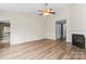 Bright and airy living room with a fireplace, hardwood floors, a ceiling fan and plenty of natural light at 7047 Whittingham Dr, Indian Land, SC 29707