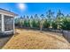 Spacious backyard with a well-manicured lawn, bordered by a black metal fence for privacy and security at 7118 Overjoyed Xing, Charlotte, NC 28215