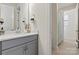 Modern bathroom with gray vanity, quartz countertop, and neutral tile flooring at 7118 Overjoyed Xing, Charlotte, NC 28215
